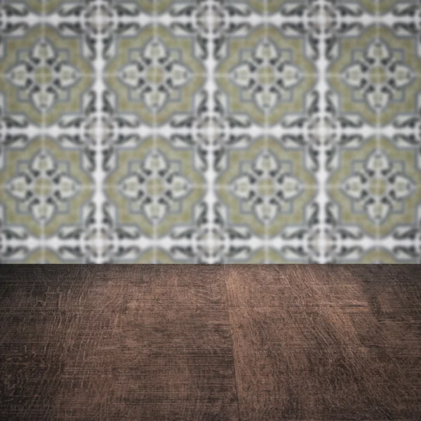 Wood table top and blur vintage ceramic tile pattern wall — Stock Photo, Image