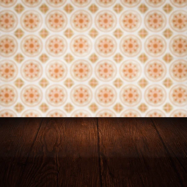 Wood table top and blur vintage ceramic tile pattern wall — Stock Photo, Image