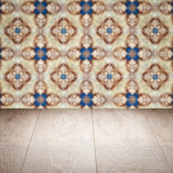 Wood table top and blur vintage ceramic tile pattern wall — Stock Photo, Image