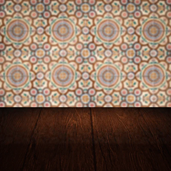 Wood table top and blur vintage ceramic tile pattern wall — Stock Photo, Image