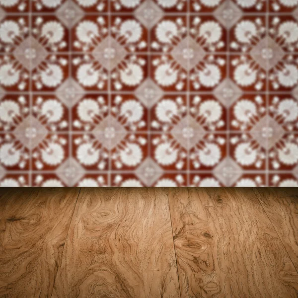 Wood table top and blur vintage ceramic tile pattern wall — Stock Photo, Image