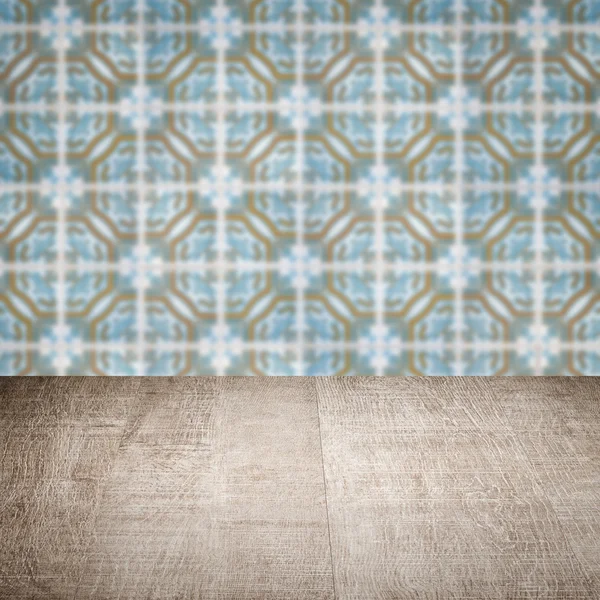 Wood table top and blur vintage ceramic tile pattern wall — Stock Photo, Image