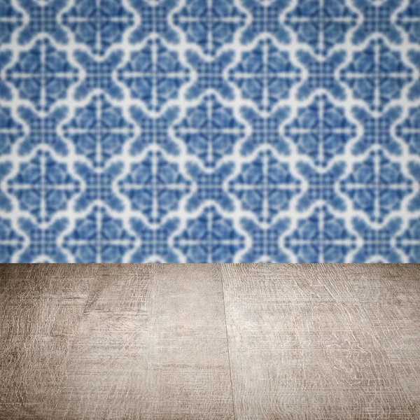 Wood table top and blur vintage ceramic tile pattern wall — Stock Photo, Image