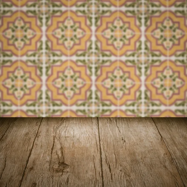 Wood table top and blur vintage ceramic tile pattern wall — Stock Photo, Image