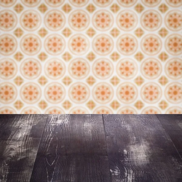 Wood table top and blur vintage ceramic tile pattern wall — Stock Photo, Image