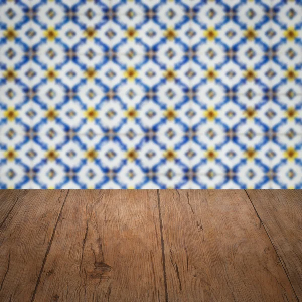 Wood table top and blur vintage ceramic tile pattern wall — Stock Photo, Image