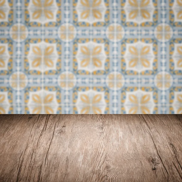 Wood table top and blur vintage ceramic tile pattern wall — Stock Photo, Image