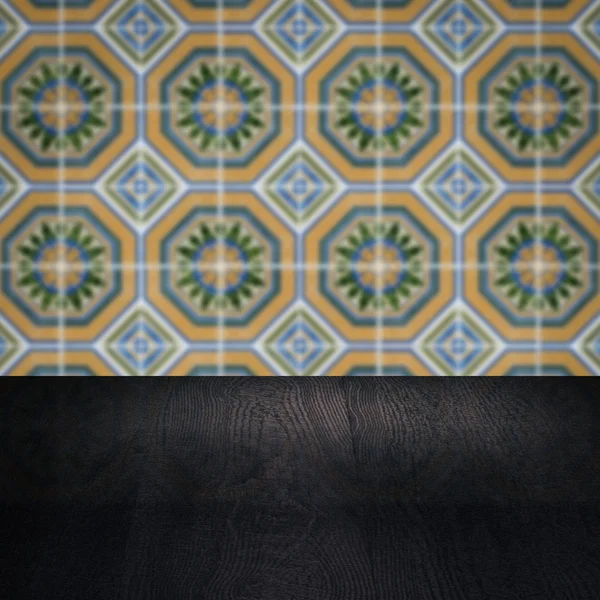 Wood table top and blur vintage ceramic tile pattern wall — Stock Photo, Image