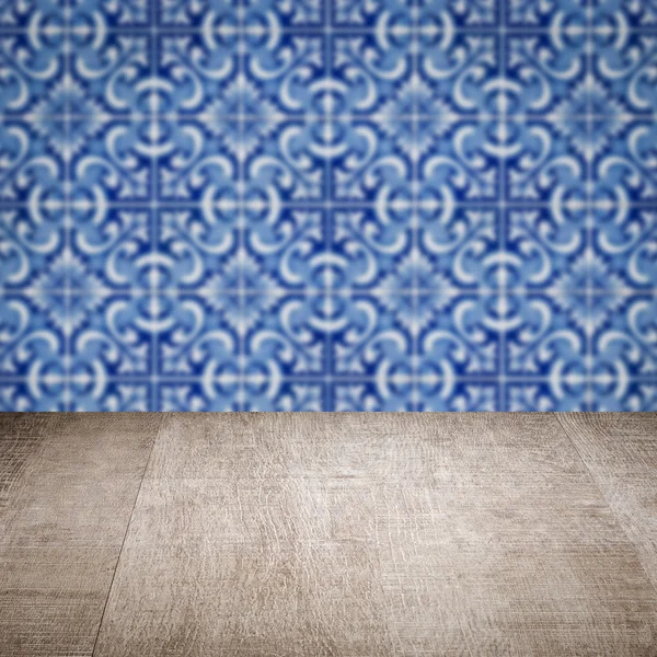 Wood table top and blur vintage ceramic tile pattern wall — Stock Photo, Image