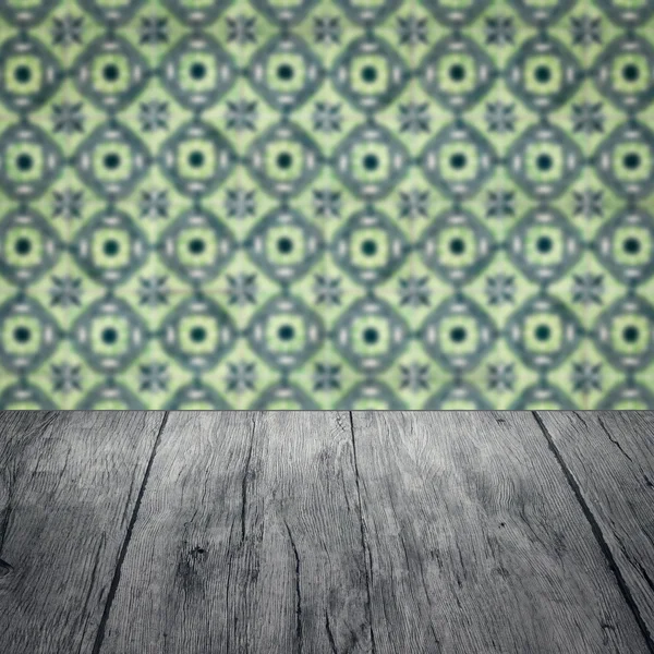 Wood table top and blur vintage ceramic tile pattern wall — Stock Photo, Image