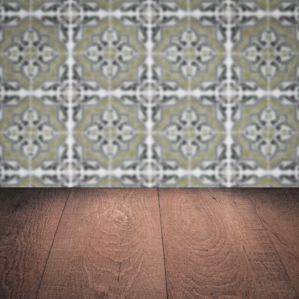 Wood table top and blur vintage ceramic tile pattern wall — Stock Photo, Image