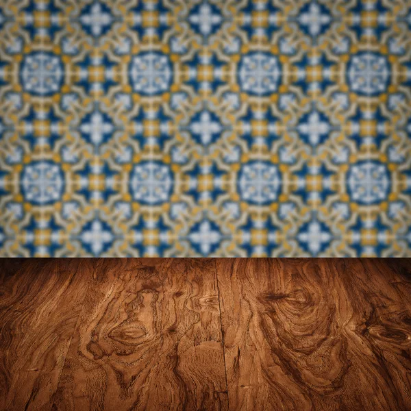 Wood table top and blur vintage ceramic tile pattern wall — Stock Photo, Image