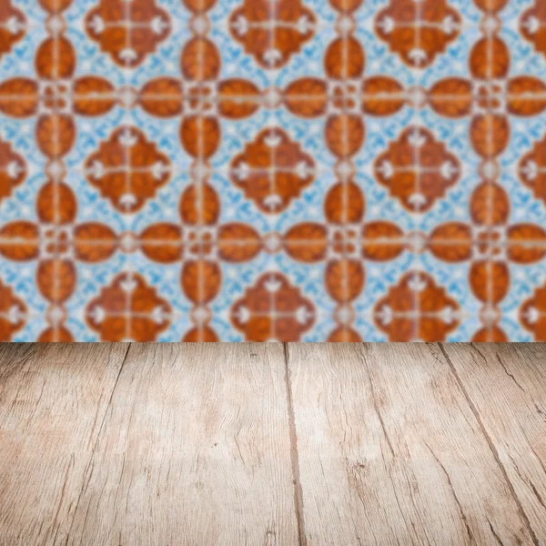 Wood table top and blur vintage ceramic tile pattern wall — Stock Photo, Image