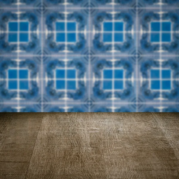 Wood table top and blur vintage ceramic tile pattern wall — Stock Photo, Image