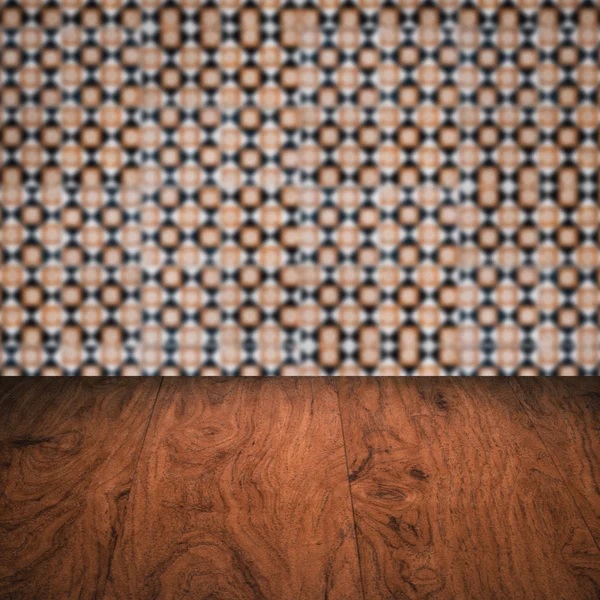 Wood table top and blur vintage ceramic tile pattern wall — Stock Photo, Image