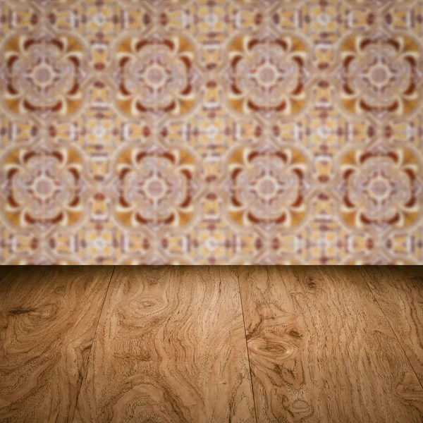 Wood table top and blur vintage ceramic tile pattern wall — Stock Photo, Image