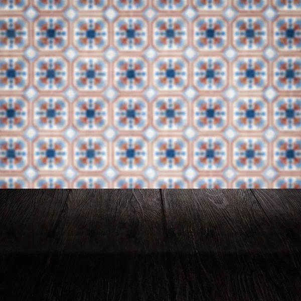 Wood table top and blur vintage ceramic tile pattern wall — Stock Photo, Image