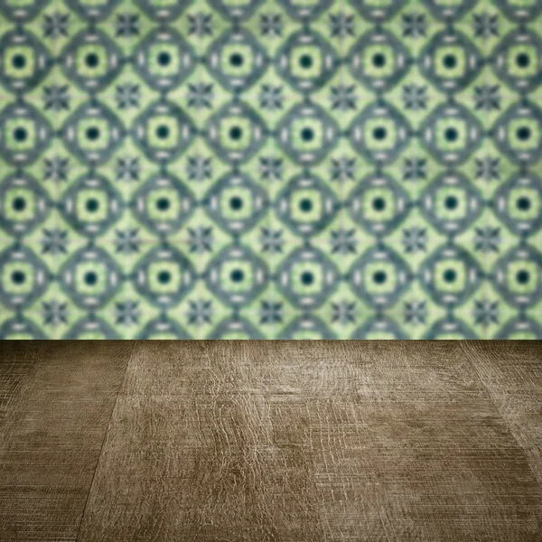 Wood table top and blur vintage ceramic tile pattern wall — Stock Photo, Image