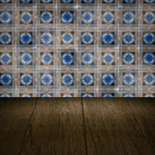 Wood table top and blur vintage ceramic tile pattern wall — Stock Photo, Image