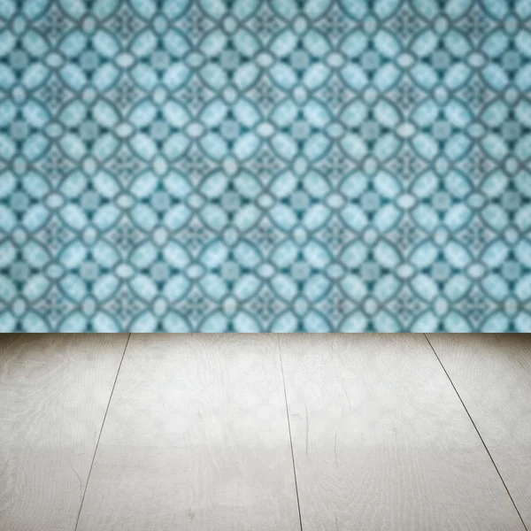 Wood table top and blur vintage ceramic tile pattern wall — Stock Photo, Image