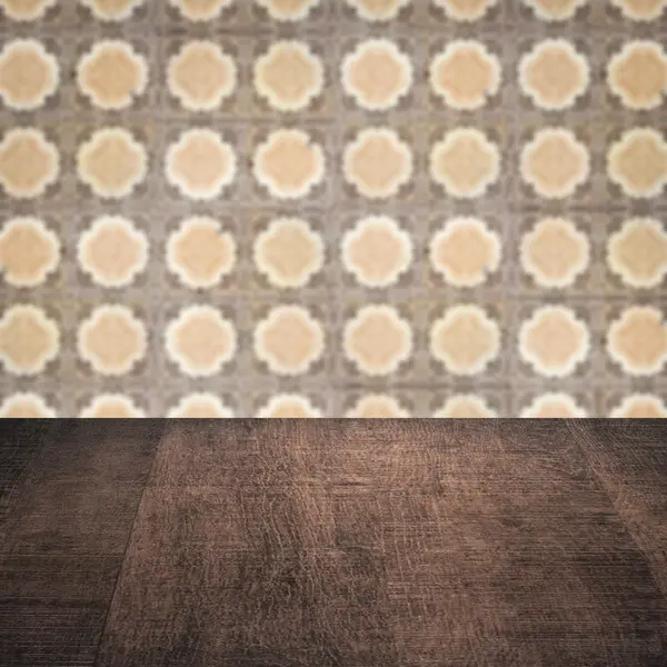 Wood table top and blur vintage ceramic tile pattern wall — Stock Photo, Image