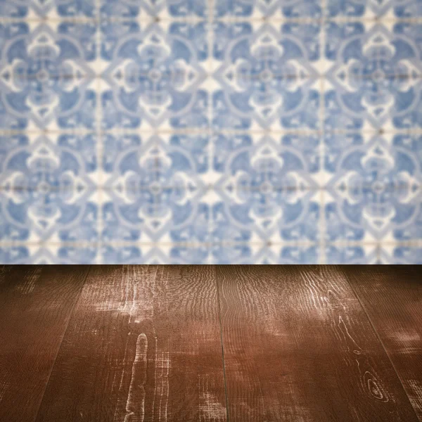 Wood table top and blur vintage ceramic tile pattern wall — Stock Photo, Image