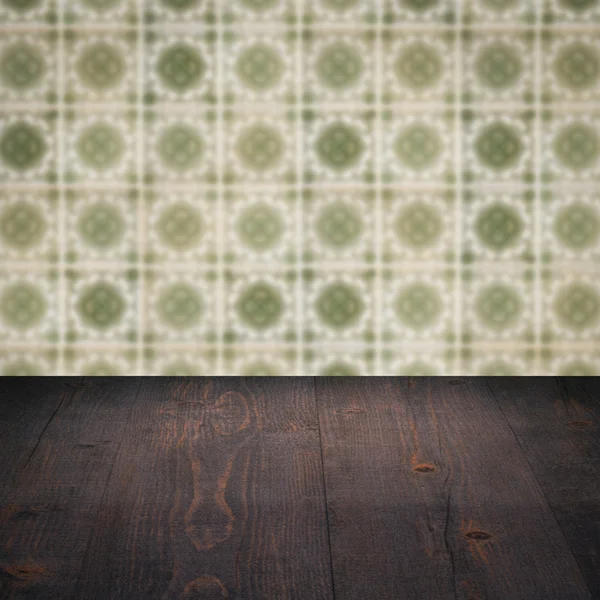 Wood table top and blur vintage ceramic tile pattern wall — Stock Photo, Image