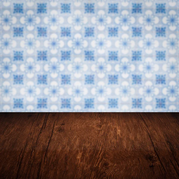 Wood table top and blur vintage ceramic tile pattern wall — Stock Photo, Image