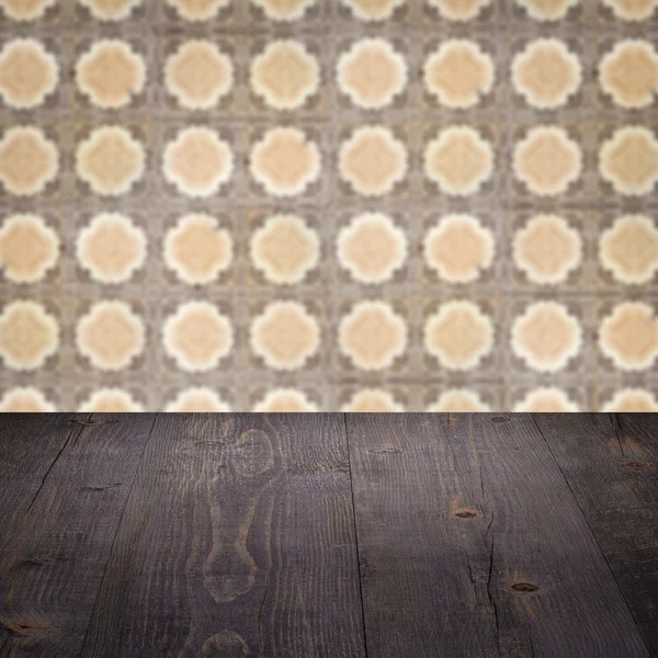 Wood table top and blur vintage ceramic tile pattern wall — Stock Photo, Image