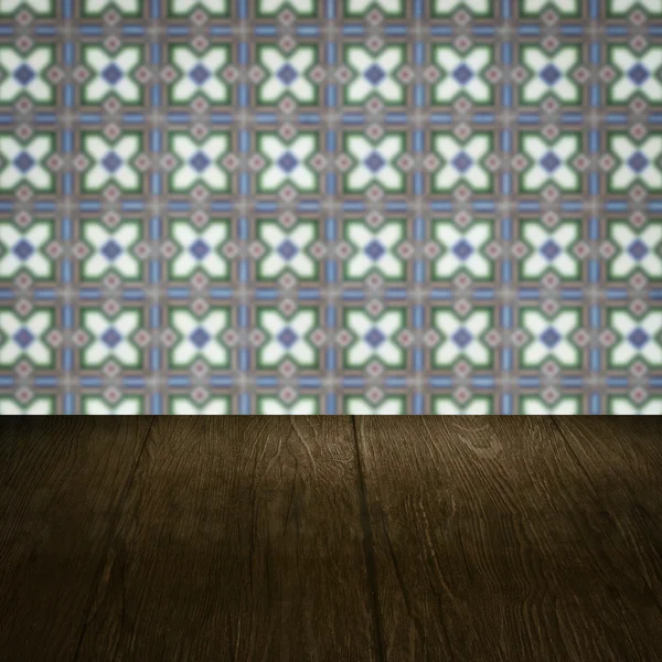 Wood table top and blur vintage ceramic tile pattern wall — Stock Photo, Image