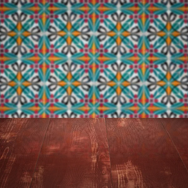 Wood table top and blur vintage ceramic tile pattern wall — Stock Photo, Image