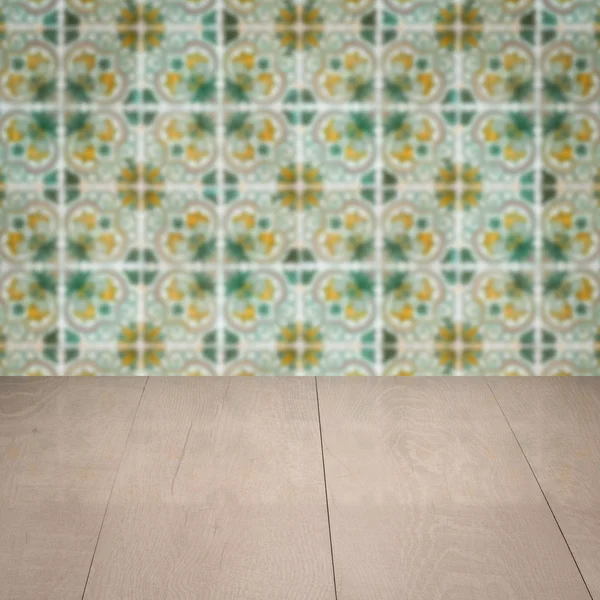 Wood table top and blur vintage ceramic tile pattern wall — Stock Photo, Image