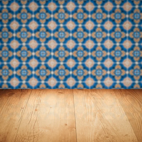 Wood table top and blur vintage ceramic tile pattern wall — Stock Photo, Image