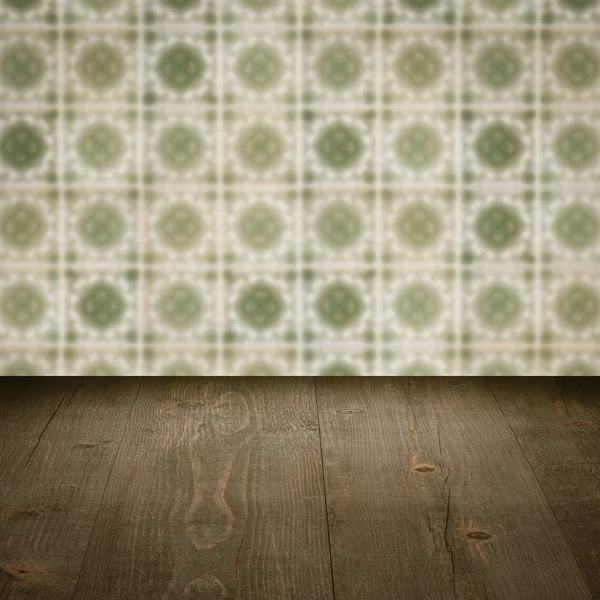 Wood table top and blur vintage ceramic tile pattern wall — Stock Photo, Image