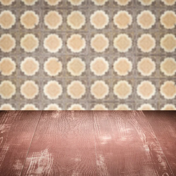 Wood table top and blur vintage ceramic tile pattern wall — Stock Photo, Image