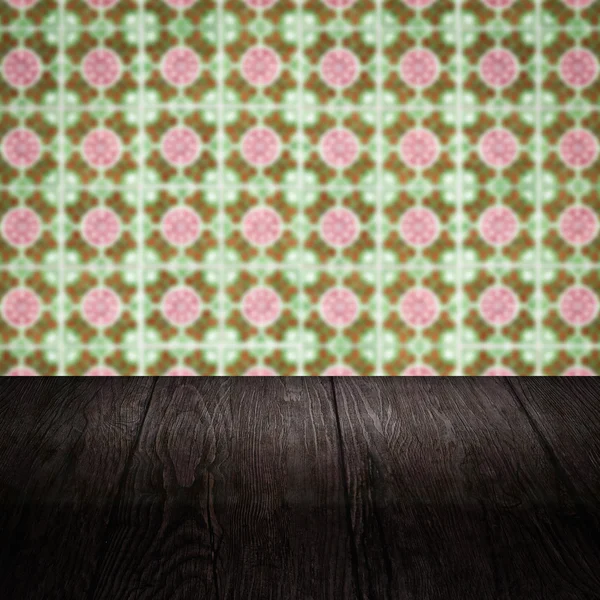 Wood table top and blur vintage ceramic tile pattern wall — Stock Photo, Image