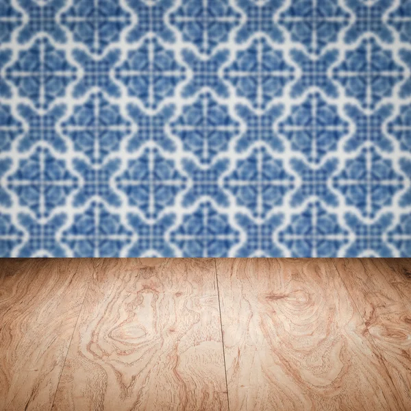 Wood table top and blur vintage ceramic tile pattern wall — Stock Photo, Image