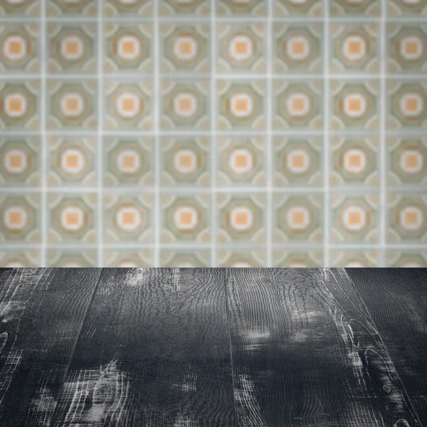 Wood table top and blur vintage ceramic tile pattern wall — Stock Photo, Image