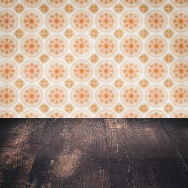 Wood table top and blur vintage ceramic tile pattern wall — Stock Photo, Image