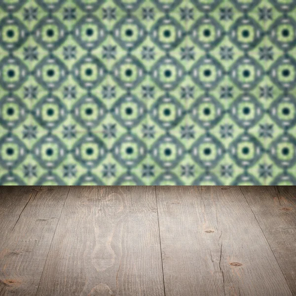 Wood table top and blur vintage ceramic tile pattern wall — Stock Photo, Image