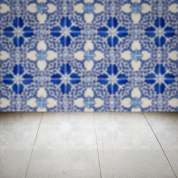 Wood table top and blur vintage ceramic tile pattern wall — Stock Photo, Image