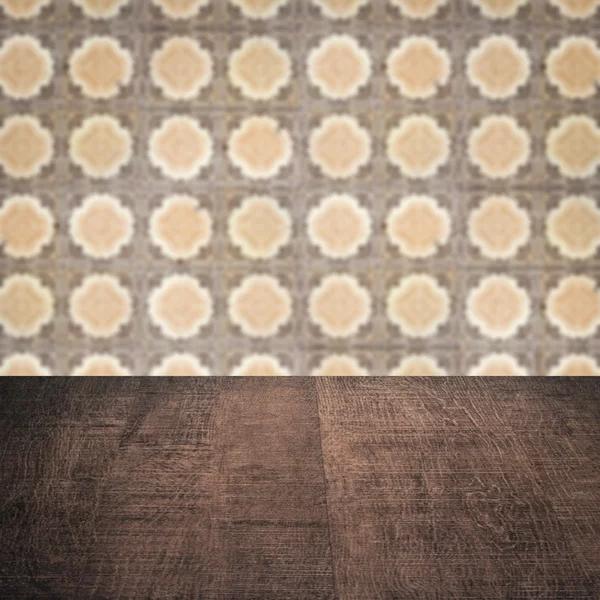 Wood table top and blur vintage ceramic tile pattern wall — Stock Photo, Image