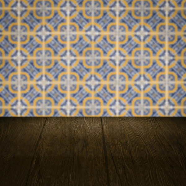 Wood table top and blur vintage ceramic tile pattern wall — Stock Photo, Image