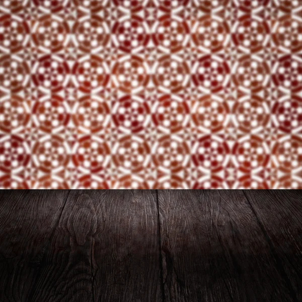 Wood table top and blur vintage ceramic tile pattern wall Stock Picture