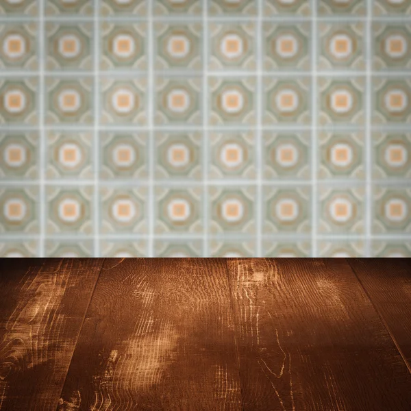 Wood table top and blur vintage ceramic tile pattern wall — Stock Photo, Image