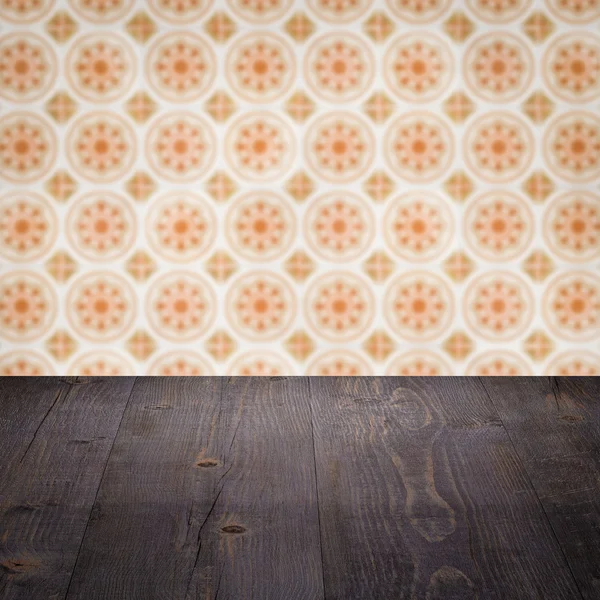 Wood table top and blur vintage ceramic tile pattern wall — Stock Photo, Image