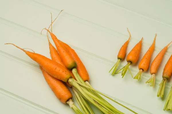 Carrots on wooden table — Stock Photo, Image