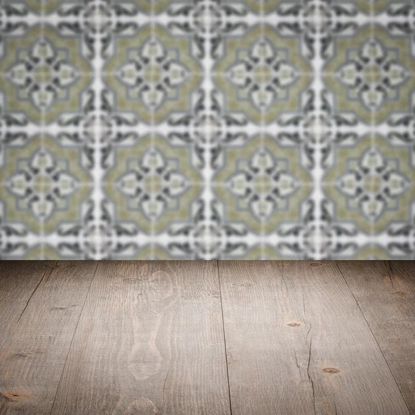 Wood table top and blur vintage ceramic tile pattern wall — Stock Photo, Image