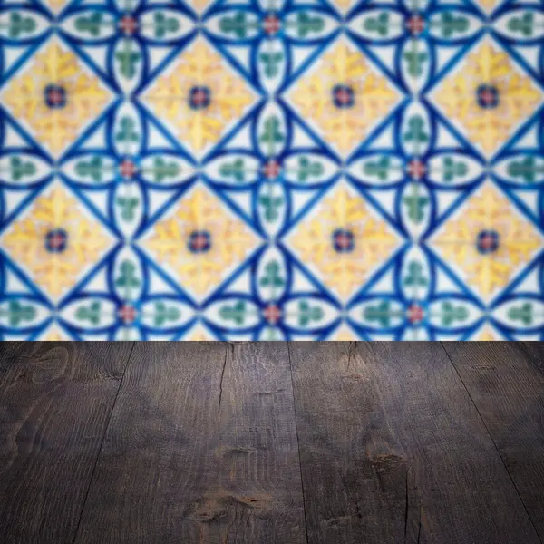 Wood table top and blur vintage ceramic tile pattern wall — Stock Photo, Image