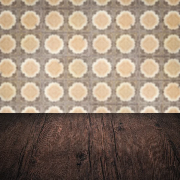 Wood table top and blur vintage ceramic tile pattern wall — Stock Photo, Image